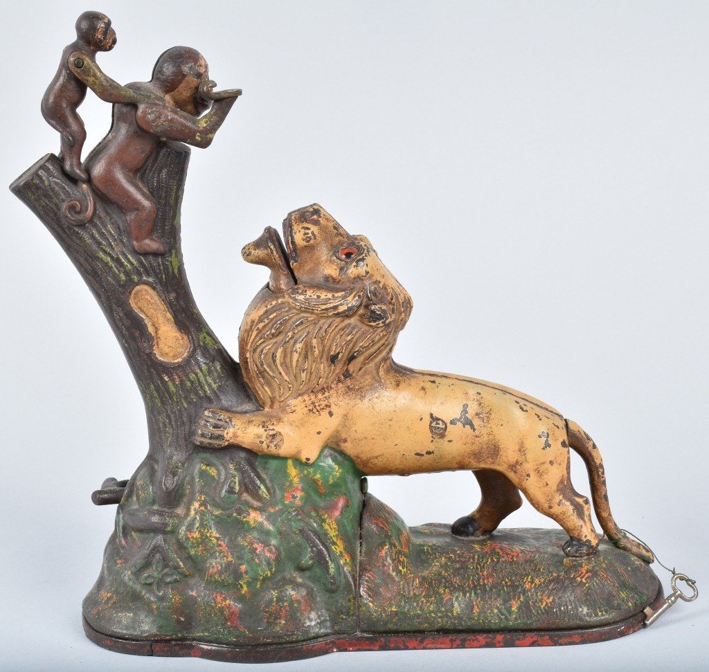 KYSER & REX LION & MONKEYS MECHAINCAL BANK: Kyser & Rex circa 1883. Place coin in monkey's hand push branch and monkey drop the coin into the lions mouth. This is a wonderful all original example. There is a crack in the base plate. Very high p