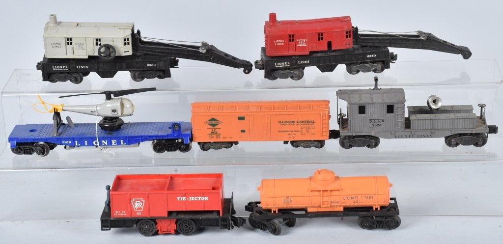 LIONEL ROLLING STOCK LOT: Nice lot with 2 No. 6560 Crane Cars, a No. 3419 Flat car with Helicopter, a No. 2420 Search light car, a No. 5511 Tie-Jector, a No. 6025 Tanker, and a No. 802 Box Car. The search light car has a chipp