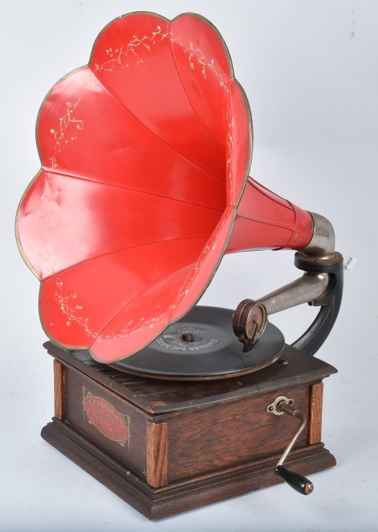 STANDARD MODEL A PHONOGRAPH: Excellent original Standard Model A Phonograph. All original with nice patina. Some waves on top of the base. Beautiful red horn with decorations. Spring needs repair. 24"x18" Very Good