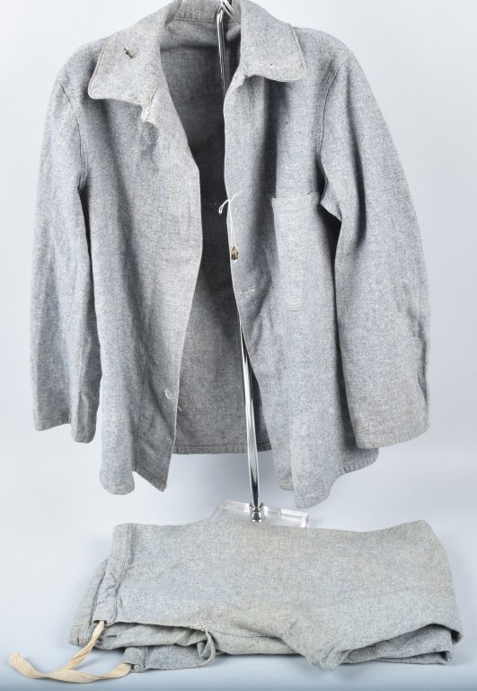 WW1 GERMAN PRISONER OF WAR UNIFORM: Appears to be a medium size. Has general wear and soiling, hole in the collar. Buttons detached but included. A scarce item to find. Very Good