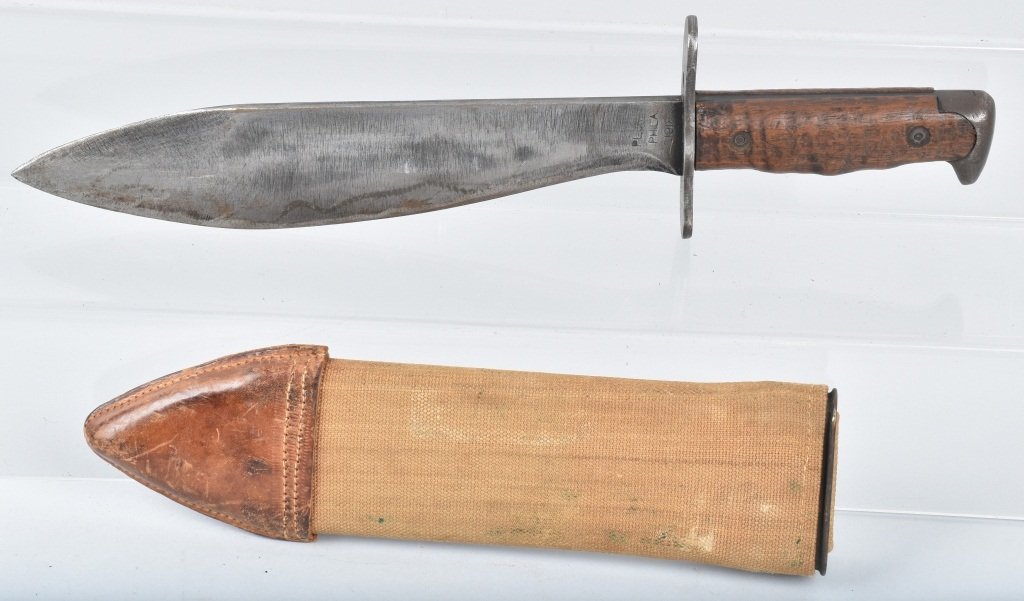 US MODEL 1917 PLUMB BOLO KNIFE & SHEATH: About 15" overall with a 10" nicely marked blade. The blade has some grind marks, the sheath is excellent. Very Good