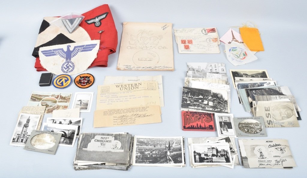 WW2 GROUPING JOHN ADAMS 522ND ORDINANCE: Great large grouping from Cpl. John Adams of the 522nd, included are many Nazi souvenirs along with capture papers, photos, letters, post cards, a lighter and the 522nd circa 1945 unit history.. Adams