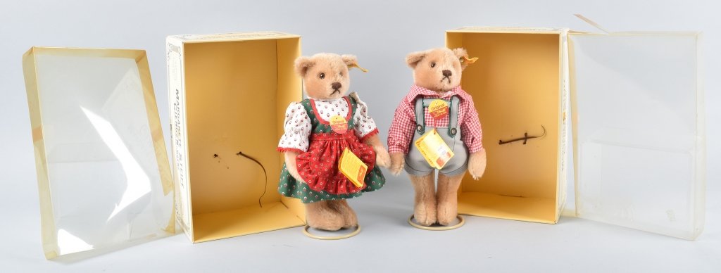 STEIFF LEDERHOSEN BOY & GIRL WITH BOXES: Steiff Lederhosen Boy & Girl with boxes. They are 11 inches, made of blonde mohair & are jointed. Made from 1986-1988. Yellow flag EAN 0275/28 for both bears. Both have steiff tag attached and paper p