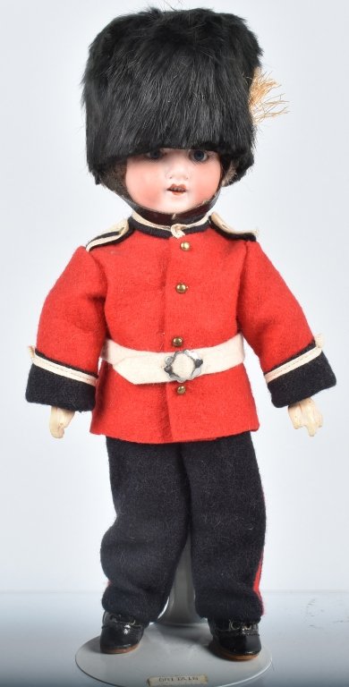 ANTIQUE ORIGINAL GERMAN BISQUE DOLL SOLDIER: The Britain soldier is approx. 9 inches. Bisque head with sleepy glass eyes. He has 4 teeth, composition body with original felt cloths. Back of head is marked Germany 390 excellent condition