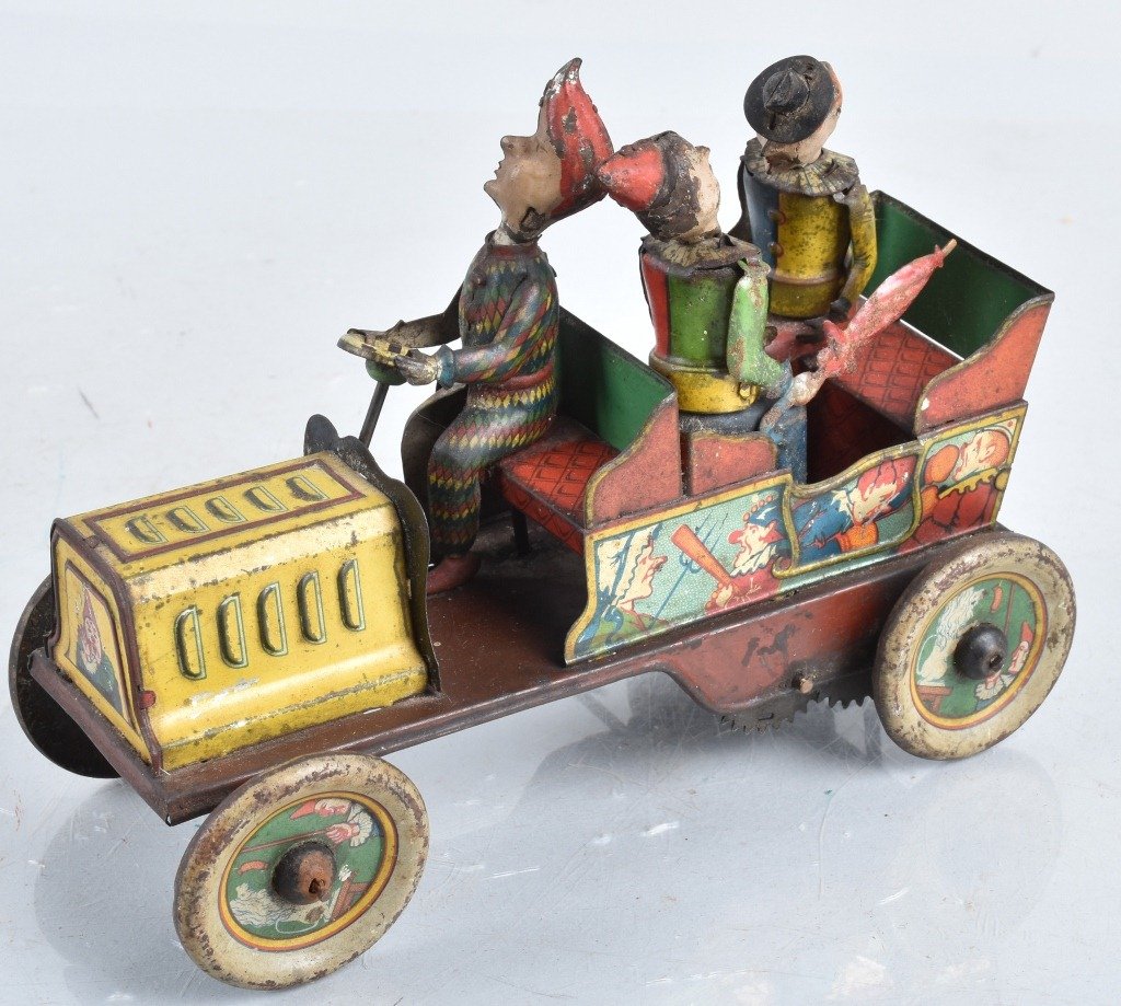 HANS EBERL Tin Windup TA RA RA BUM CLOWN CAR: Scarce tin windup clown car made in Germany. All original and complete. Has nice color and wonderful graphics. Windup works. Does have some wear. A rare and desriable tin car! 7" Very Good