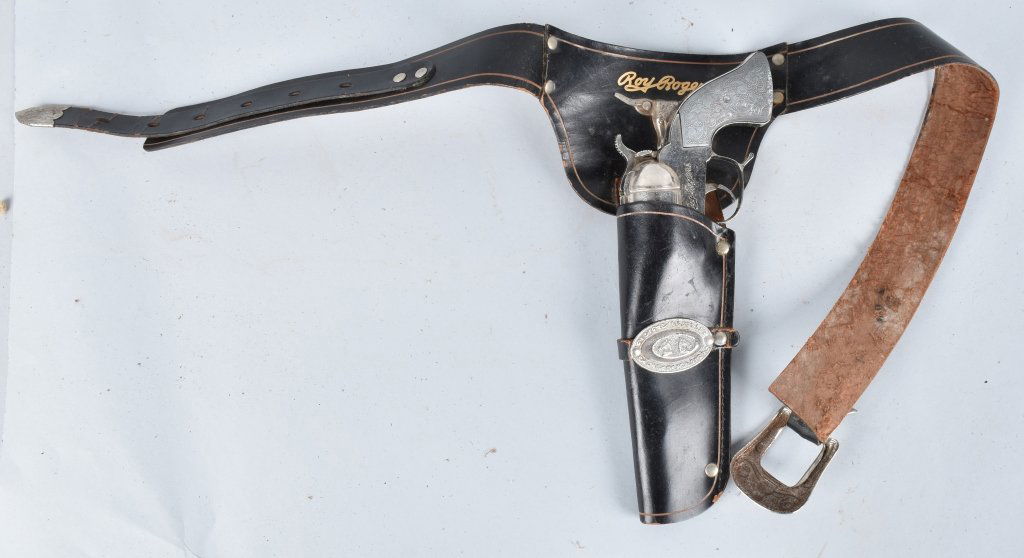 CLASSY ROY ROGERS HOLSTER SET: Set includes 10" gun with metal grips that worked when tested. General wear. Includes matching holster. Very Good-Excellent