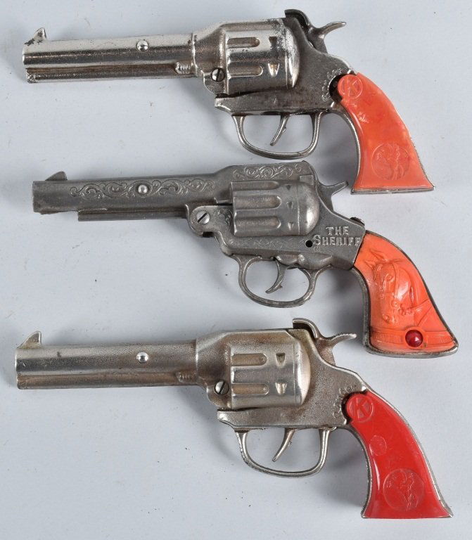 3-CAST IRON CAP GUNS, with COLORED PLASTIC GRIPS (1 of 2)