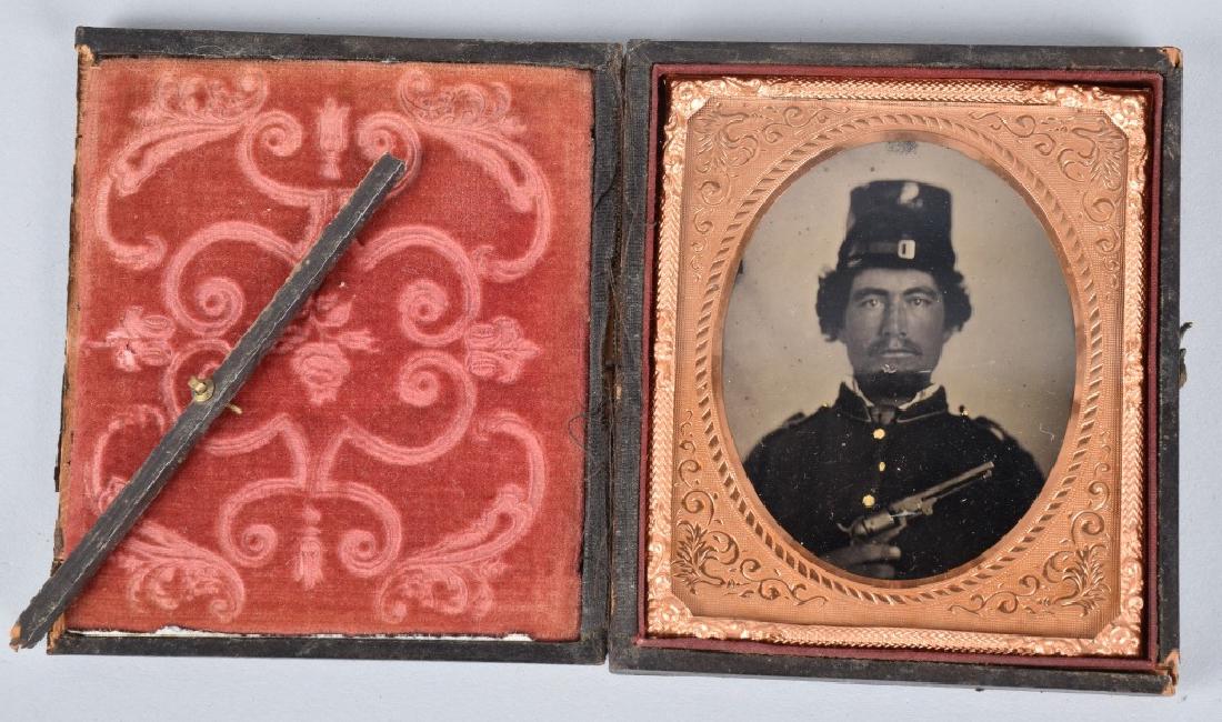 CIVIL WAR 1/6 RUBY AMBROTYPE SOLDIER with COLT: Nice ambrotype with view of Federal soldier with M1849 Colt Pocket and forage cap. Image has nice clarity and contrast. Unidentified. Leatherette case detached at spine and has damage. Excellent