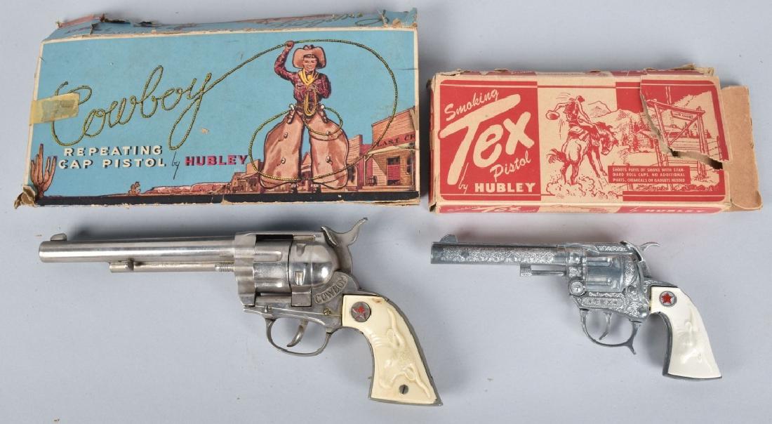 2-BOXED HUBLEY CAP GUNS, COWBOY & TEX: Both guns work well and appear unfired. Light wear. Original boxes have wear and tears. Excellent