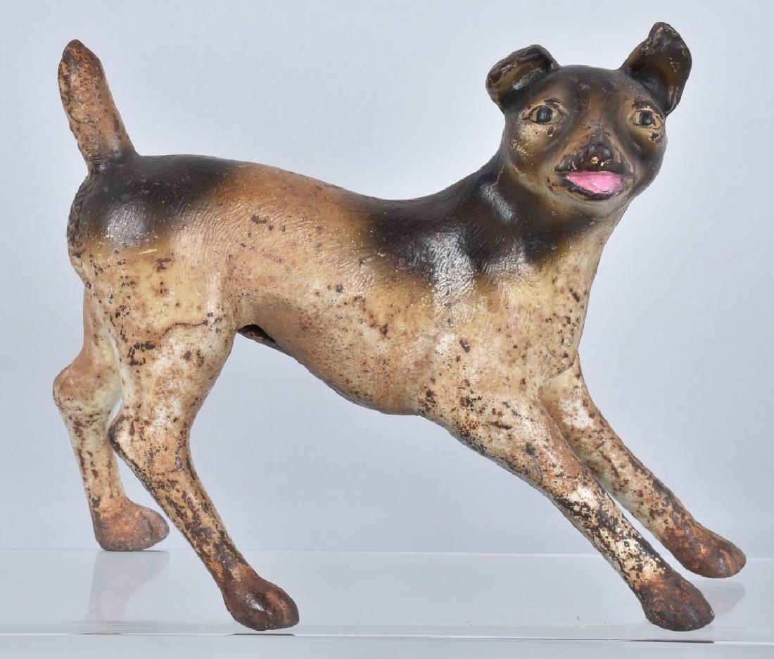 CROUCHING FOX TERRIER CAST IRON DOORSTOP: 9" by 8", scarce doorstop in the form of a crouching Terrier dog. Nice colors and casting. General wear. Very Good