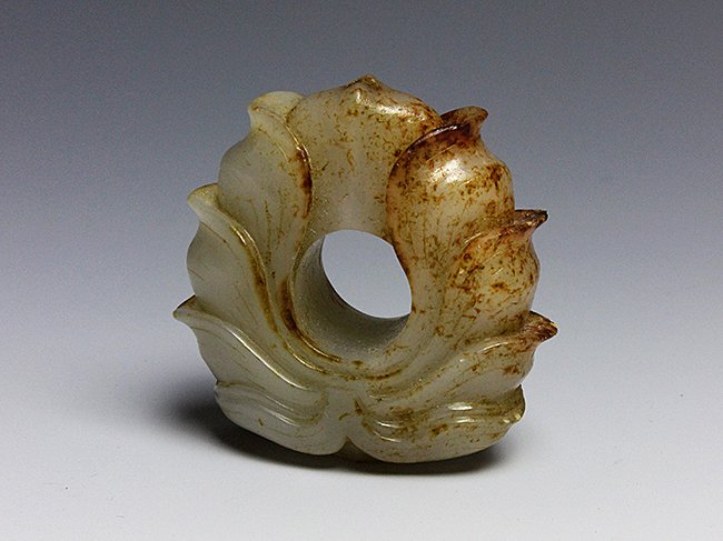 A nephrite jade carving with petals.: 唐 白玉佩 Tang Dynasty. 1 3/4in. Inch (4.4cm.) H Cm