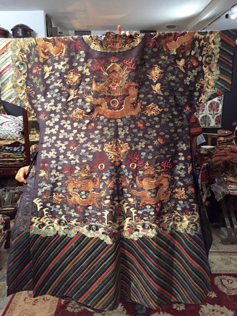 Chinese Blue Silk Embroidered 'Dragons' Robe TEXTILE: Chinese blue silk embroidered imperial style 'Dragons' robe, the front with the design of three writhing dragons and flaming pearls amid clouds, all above waves and a typical Lishui border on navy blu