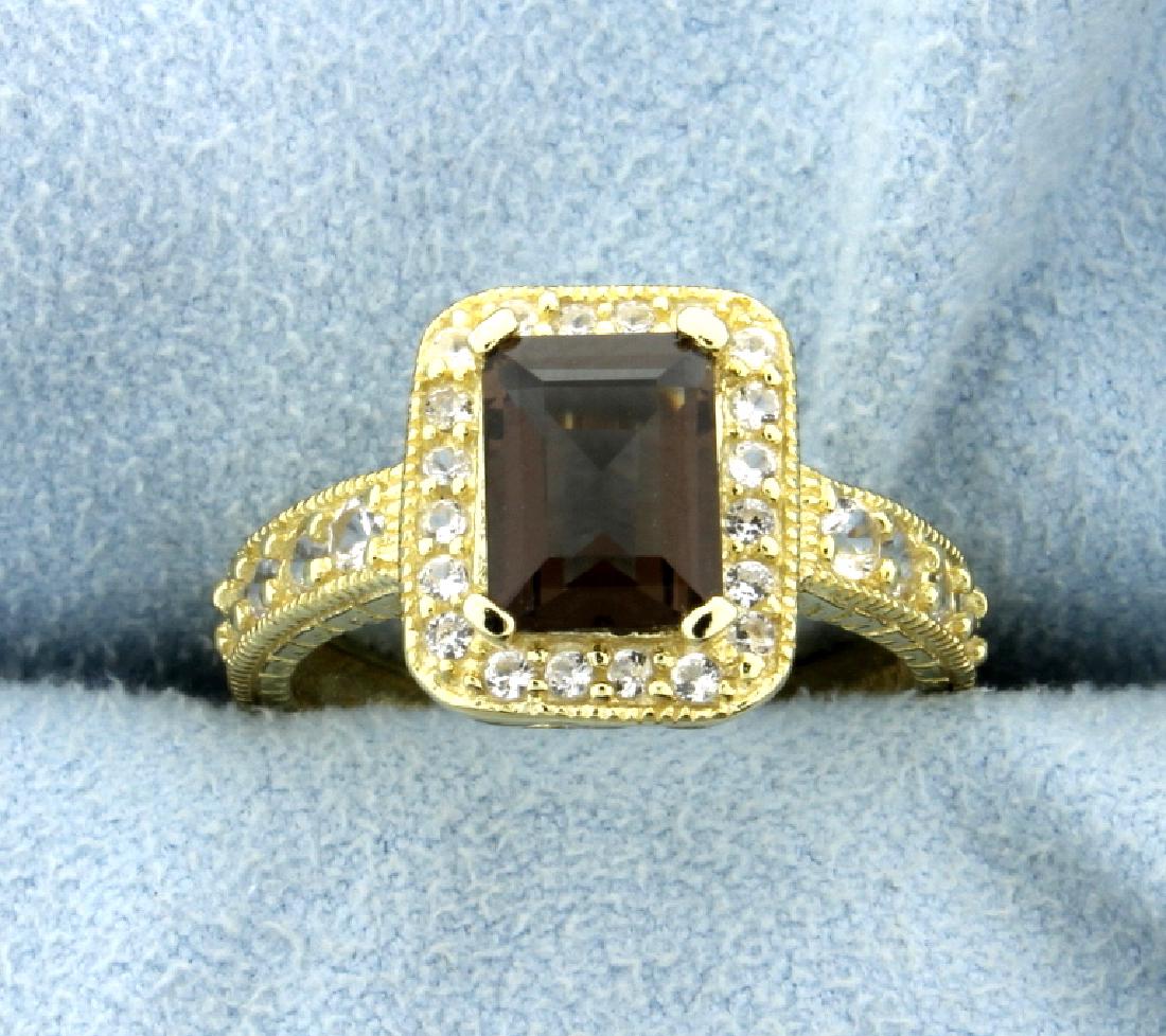 Halo Style Citrine Ring in 14k Yellow Gold over: Large 8x6mm emerald cut, deep color genuine Citrine gemstone ring surrounded by a halo of White Sapphire gems, set in 14k yellow gold over sterling silver. The mounting has gorgeous detail from all an