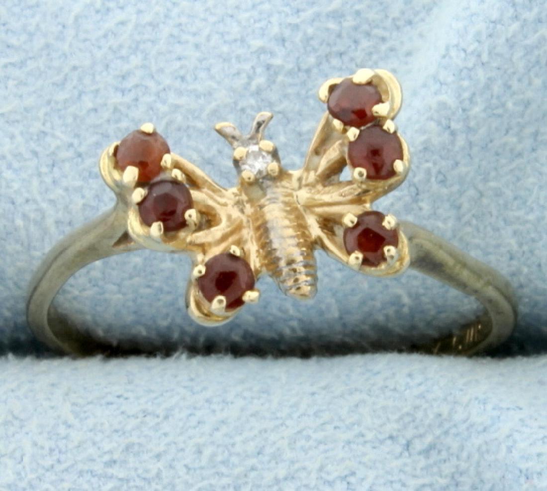 Diamond and Garnet Butterfly Ring: In 10K yellow gold, it contains six 2mm round garnet gemstones and one .01ct diamond. Size 8 3/4 2.0g