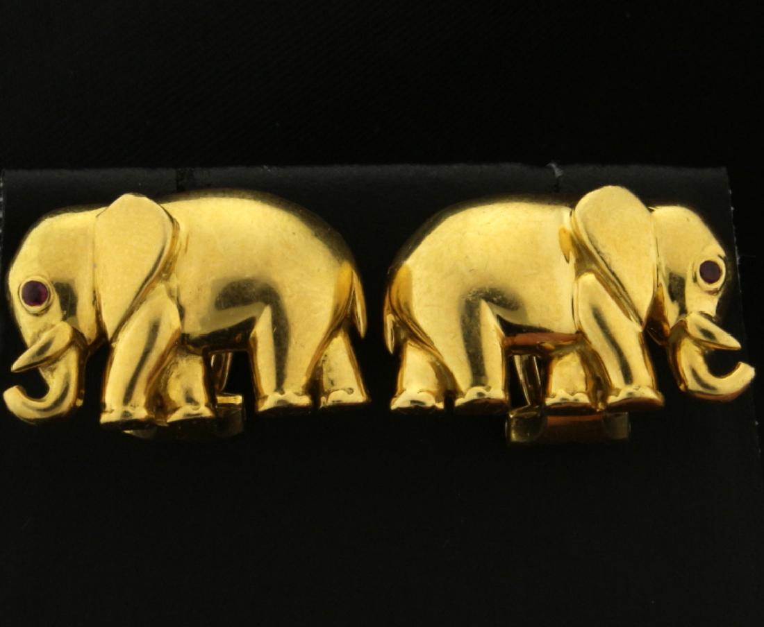 18k Elephant Earrings: In 18k yellow gold. The elephant has a 1.25mm ruby as an eye. 3/4 inch long with friction backs. 11.0g.