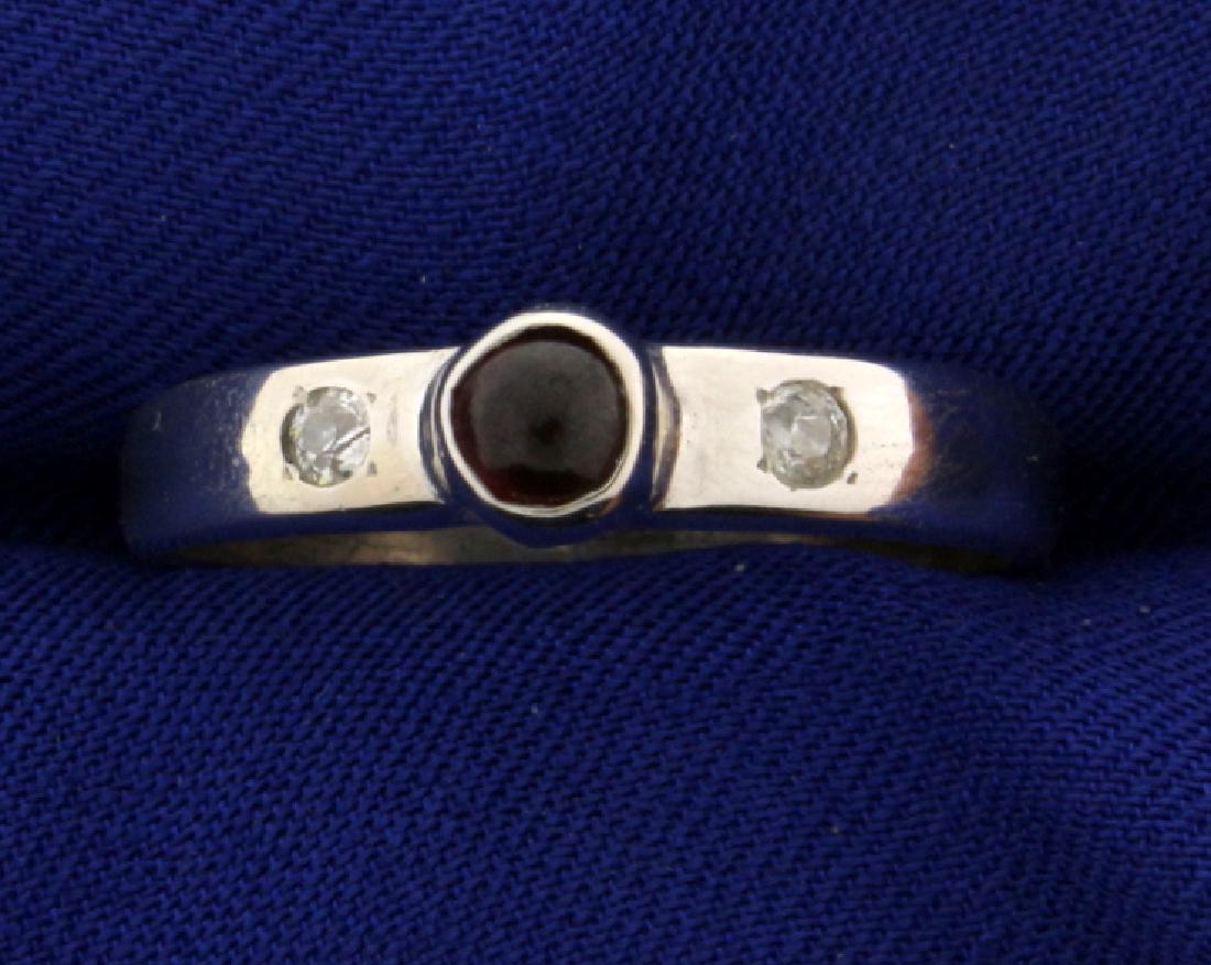 Garnet and Diamond Men's Ring: In 14k white gold, containing one cabochon 5mm garnet gemstone. Also contains two high quality .05ct old european cut diamonds SI clarity/H color. Size 11 1/4. 5.0g.