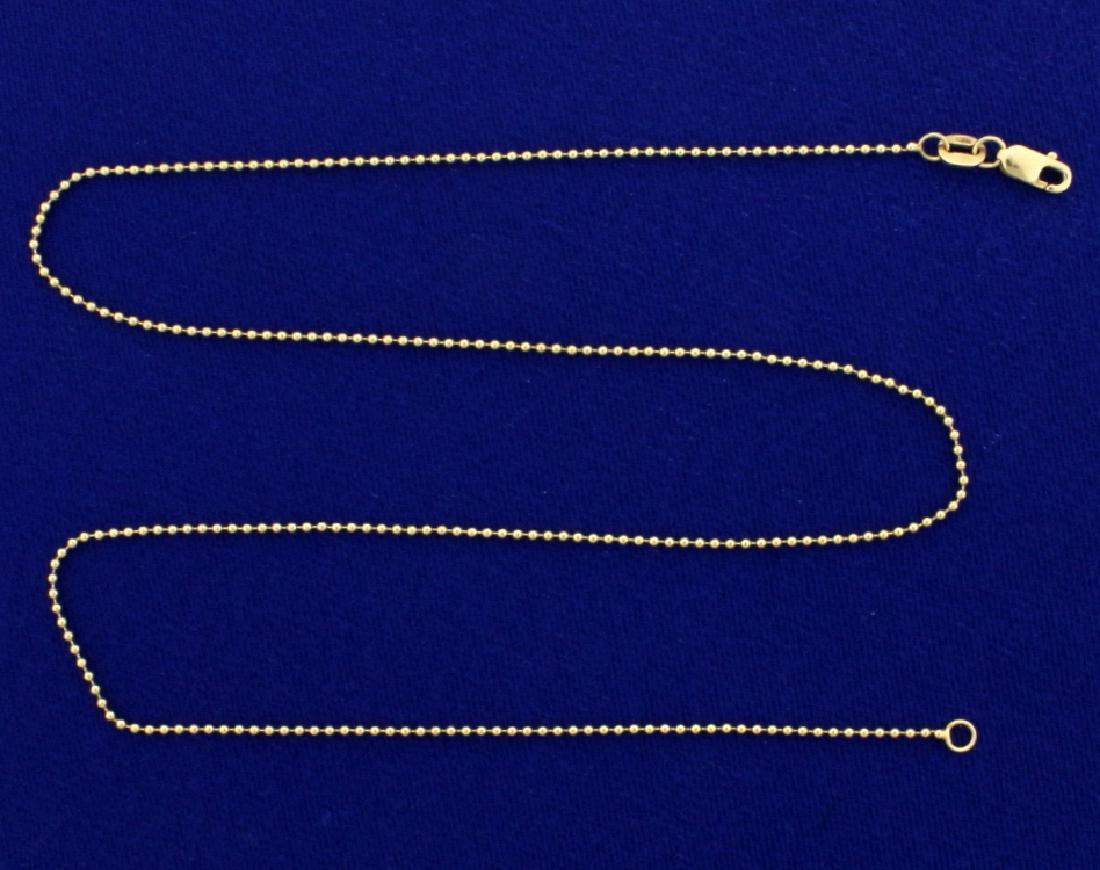 17 Inch Ball Link Neck Chain: In 14k yellow gold. 1.18mm thick with lobster clasp. 2.3g.