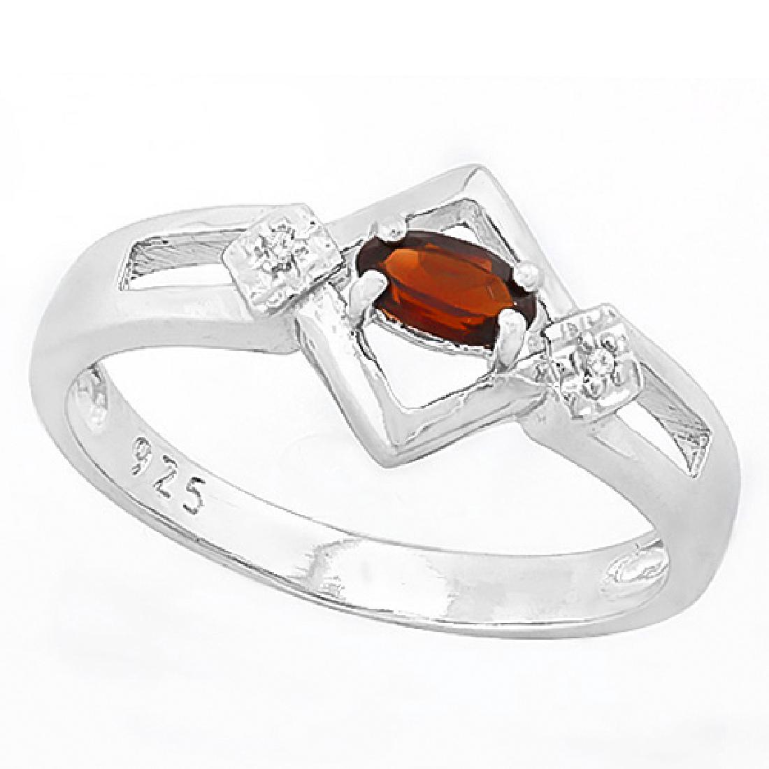 Art Deco Inspired Garnet and Diamond Ring in Sterling: Art Deco inspired ring with 1/3ct oval cut Garnet gemstone and 0.01ctw diamond accent. Set in Platinum over Sterling Silver. Size 8. 2.2g