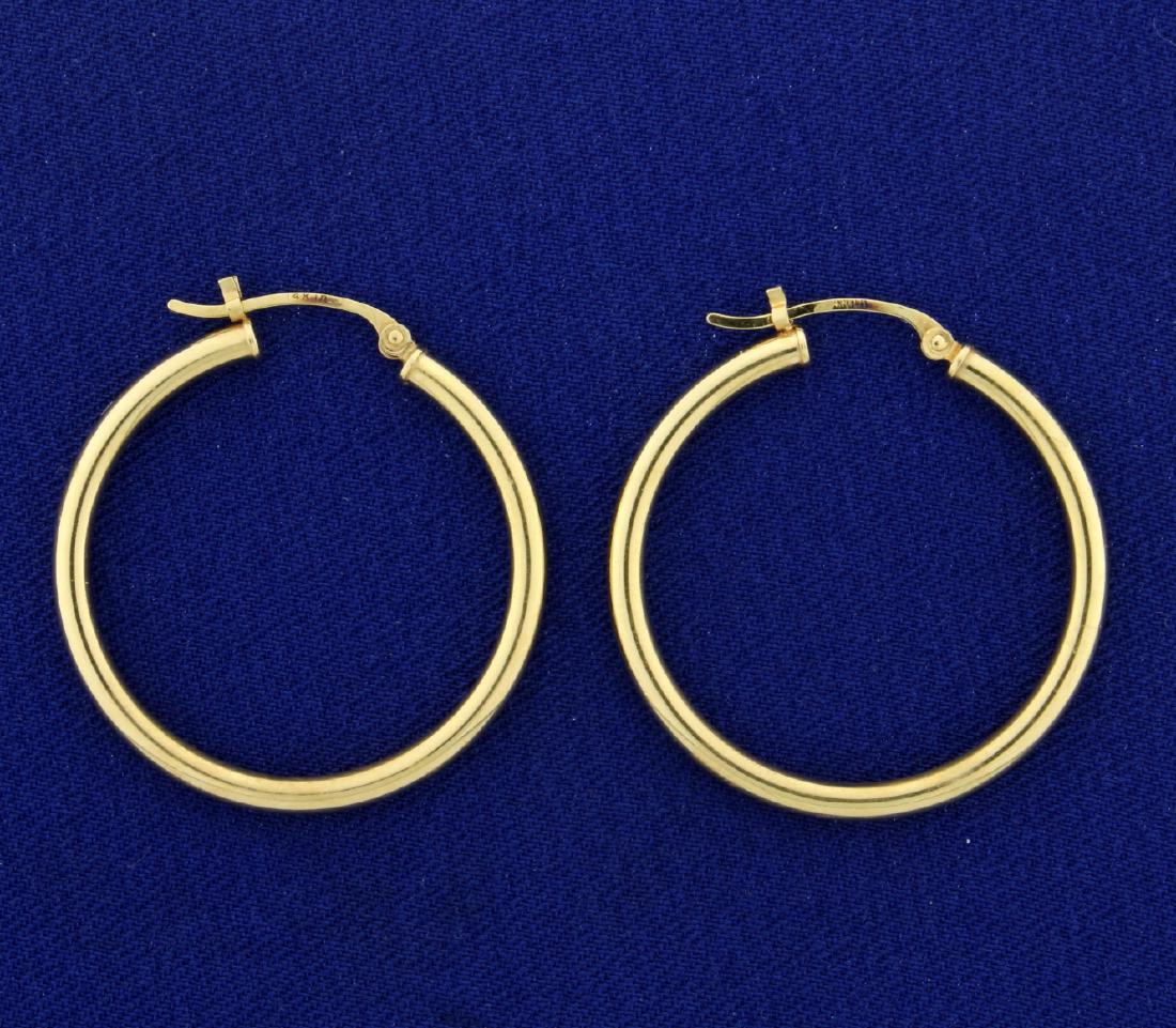 1 Inch Diameter Hoop Earrings: In 14k yellow gold. Hatch openings. 1.8g.