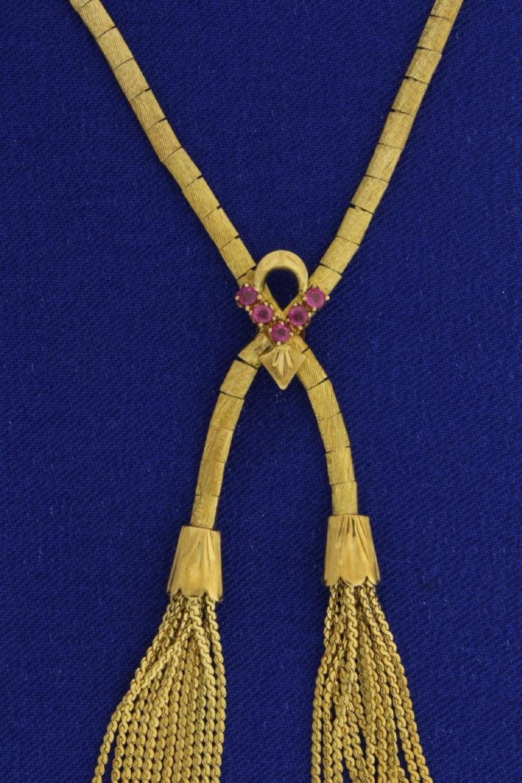 18k Lariat Tassel Necklace with Rubies: In 18k yellow gold, 20 inches long. Contains five 2mm natural rubies with safety clasp. 23.2g