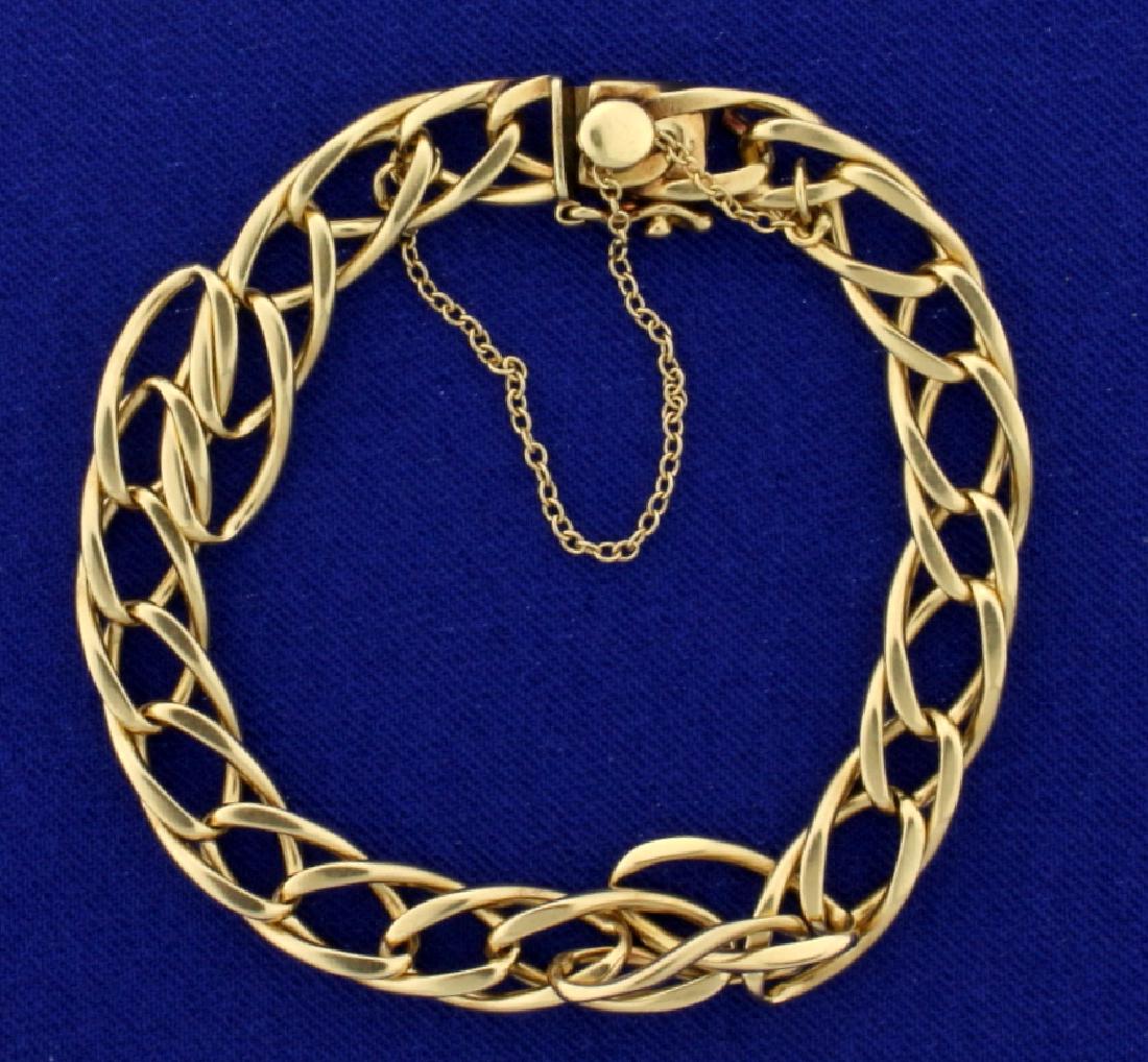 7 Inch Twisting Oval Link Bracelet in 14k Gold: In 14k Yellow Gold. Overlapping oval links. 7.8mm bracelet with safety chain and safety clasp. 7 inches long. 17.4g