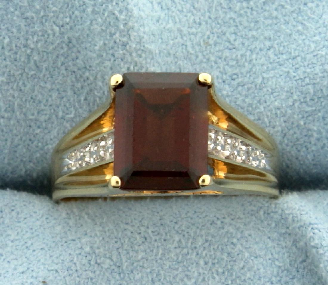 Garnet and Diamond Ring: In 10k yellow gold. Contains a 2.5ct emerald shaped natural garnet gemstone with deep red color and excellent clarity. Also contains six .005ct high quality diamonds. Size 6 1/2. 3.6g.