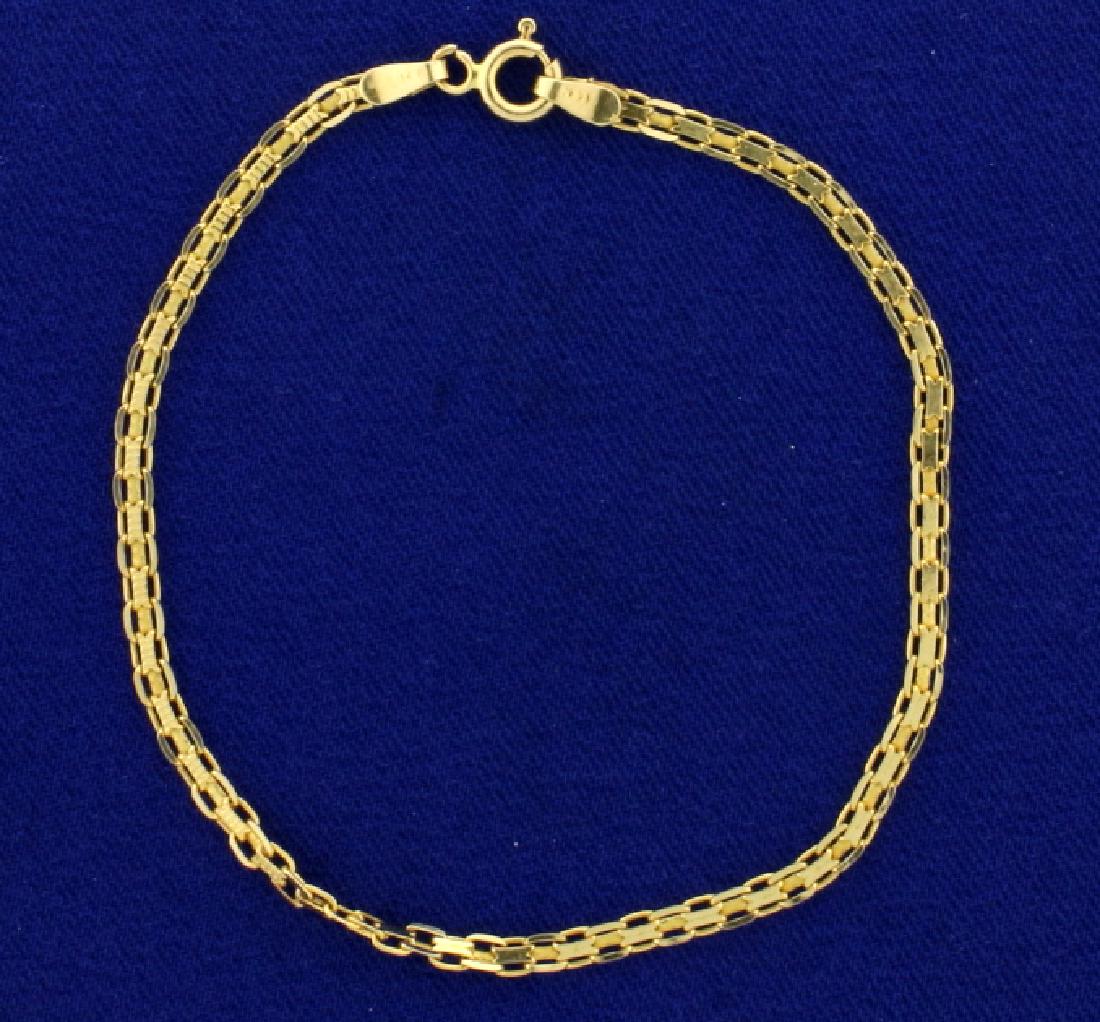 7 Inch Flat Box Link Chain Bracelet: In 14k yellow gold. 2.5mm wide. 2.2g.