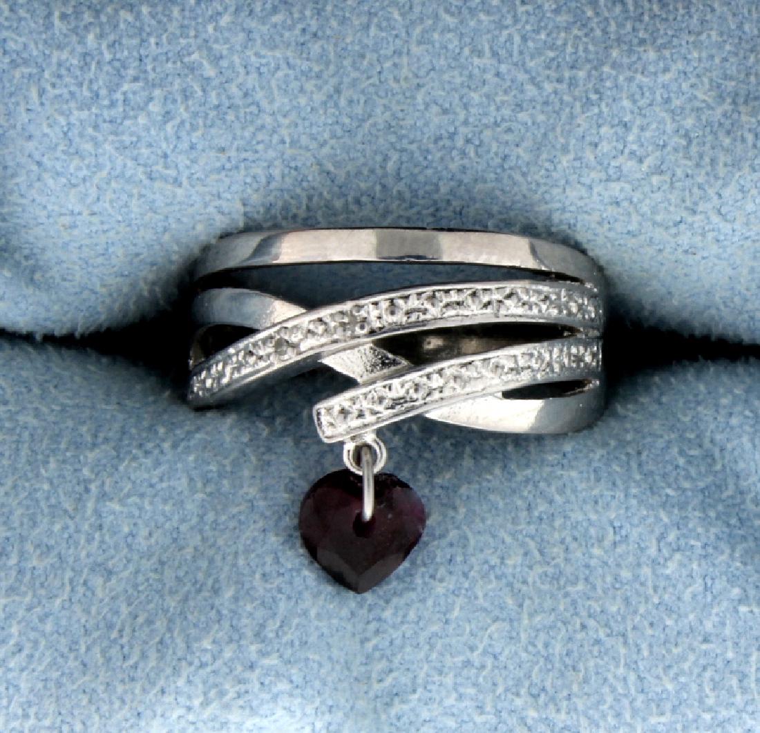 Heart Garnet and Diamond Ring in Sterling Silver: Contains a 1 carat Garnet, heart-shaped gemstone accented with two .01 ct Diamonds. Set in platinum over a sterling silver setting. Size 7.25. 3.2g.