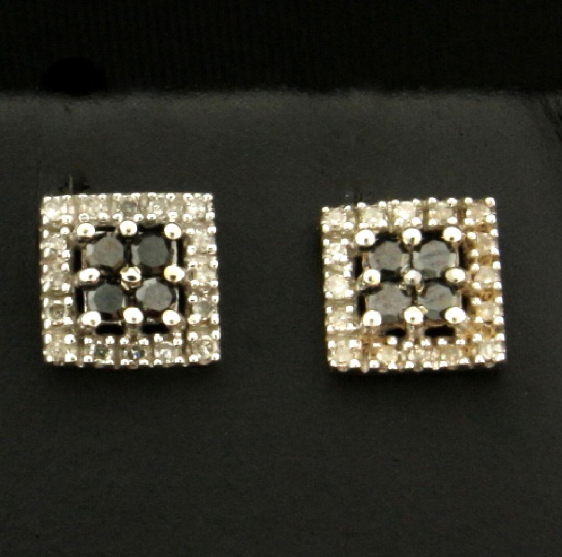 Black and White Diamond Earrings in 10k White Gold: In 10k white gold. Contains eight high quality black diamonds and thirty two high quality 1/2pt white diamonds. Screw back posts for safety. 1.1g.