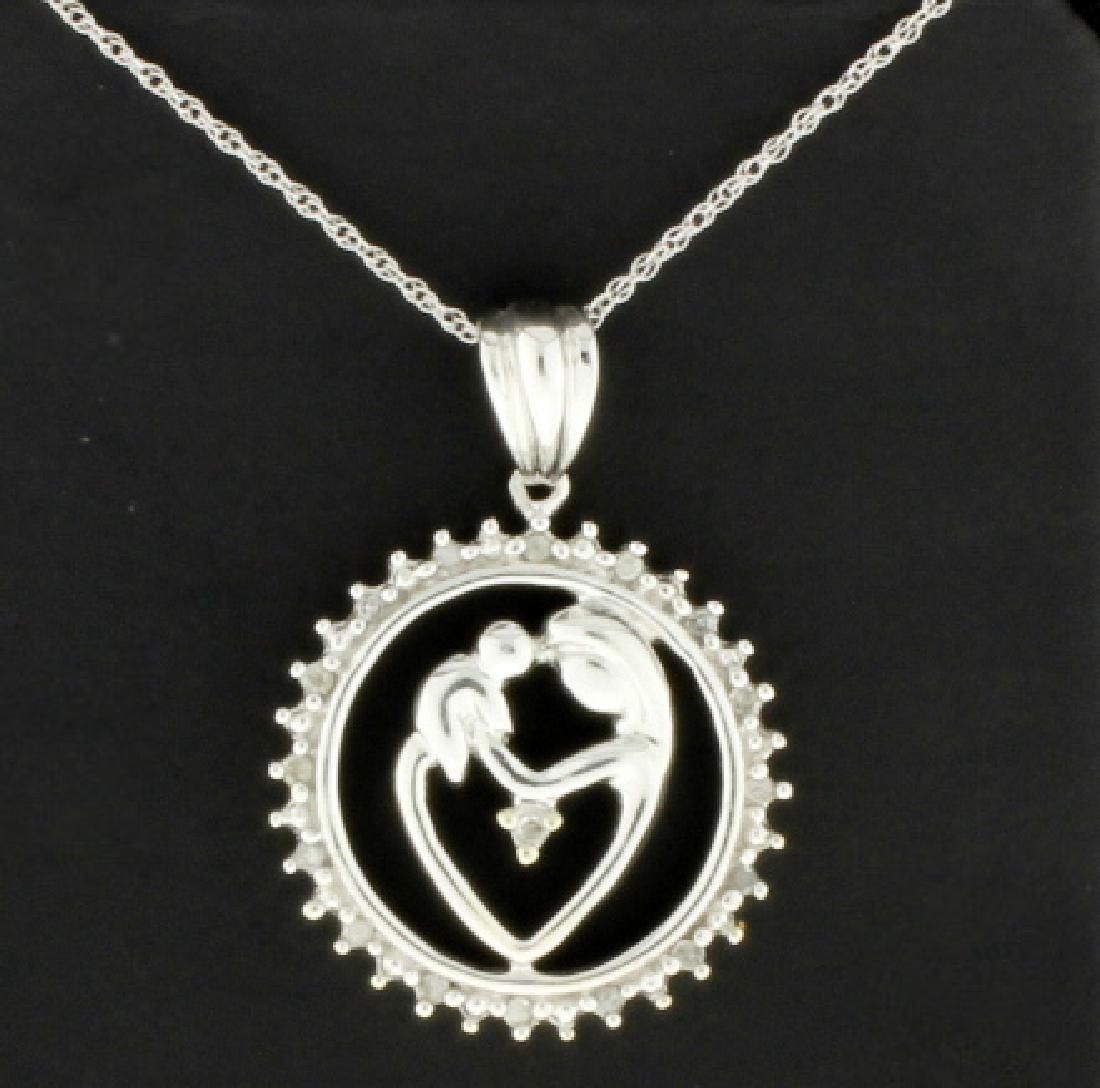 Mother and Child 1/4 Ct TW Diamond Pendant and Chain: In 10k White Gold. Contains 1/4 ct of high quality round brilliant diamonds, I color/I clarity. Pendant is 1 inch long. The 10K white gold chain is 18" in length. 3.2g