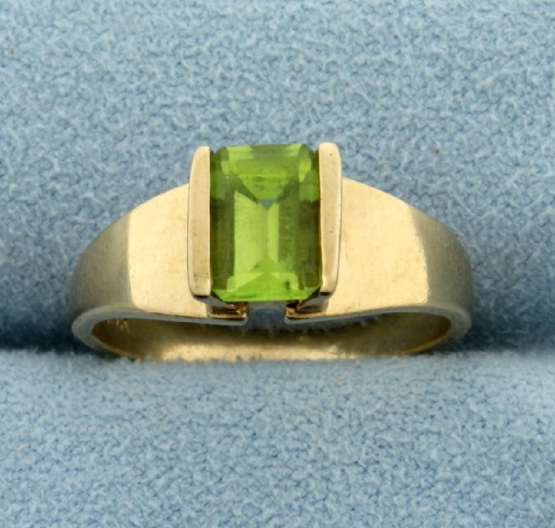 Emerald Cut Peridot Ring: In 10k yellow gold. Contains 1ct natural green peridot with bright green color and excellent clarity. Size 6 with a 2.6mm band. 3.1g.