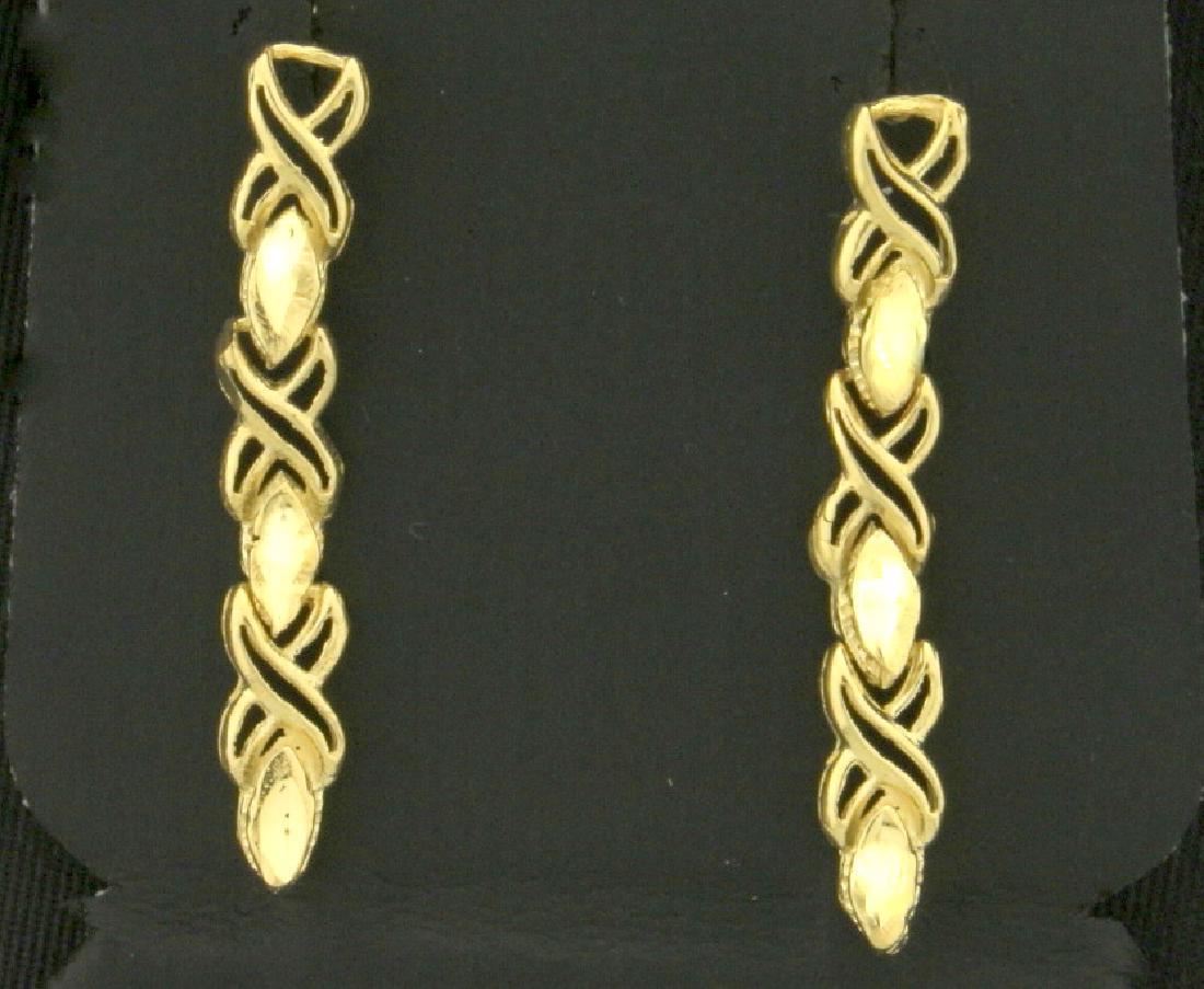 Linked Criss-Cross Dangle Earrings: In 14k yellow gold. 1 1/4" long with friction backs. 2.1g.