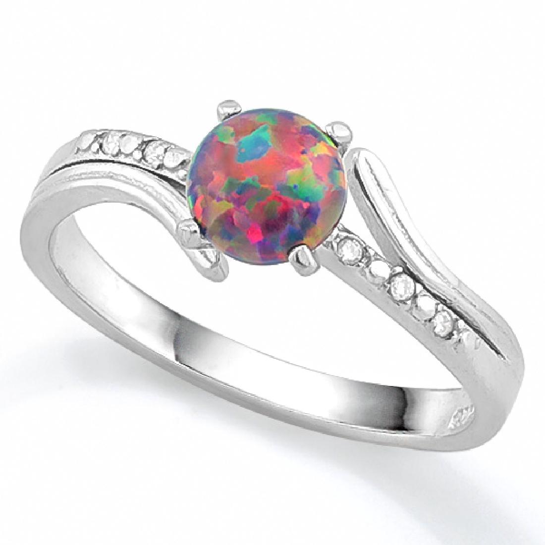 Black Opal and White Sapphire Ring in Sterling Silver: Vibrant created Black Opal is 0.40cts, set in a bypass design Platinum over Sterling Silver mounting with 0.06CTW created micro set White Sapphire gemstones in the shank. Lots of flashes of color! Siz