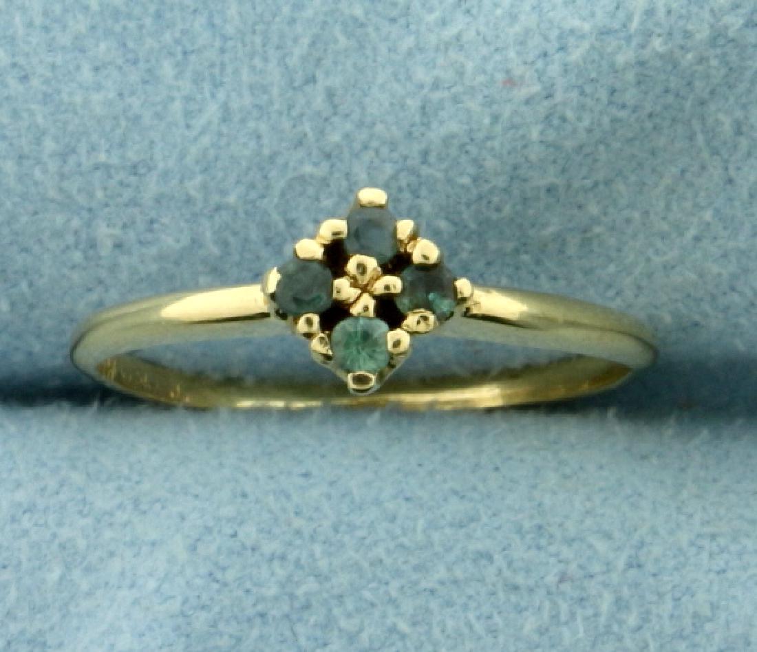 4-Stone Color Changing Alexandrite Petite Stacking Ring: In 14K Yellow Gold. Contains four 2mm round cut Alexandrite gemstones that change color from green to red depending on light source. Set in diamond pattern. 6.3mm wide on top pattern. Size 5 3/4. 1.4g