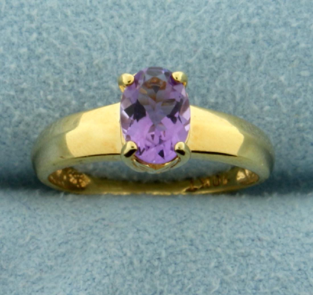 1ct Amethyst Solitaire Gold Ring: In 10K Yellow Gold. Contains a natural 7x5mm oval shaped amethyst gemstone with a bright purple bright color and excellent clarity. Size 5. 1.8g