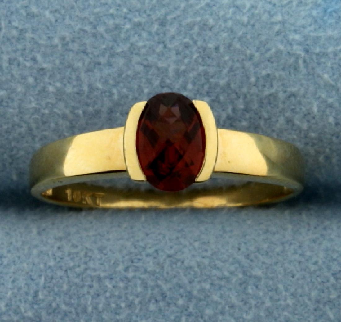 1ct Natural Garnet Gemstone Ring: In 10K Yellow Gold. Contains a natural 7x5mm oval garnet gemstone with great auburn color and excellent clarity. Size 8 1/4. 2.2g