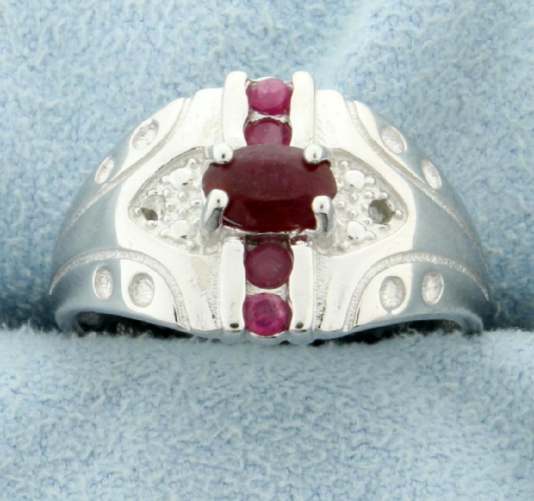 African Ruby and Diamond Fashion Ring: Set in platinum over sterling silver. Center ruby is 6x4mm Natural Ruby with beautiful ruby red color. Also contains two 1/2 pt diamonds. Size 7 1/2 4.0g