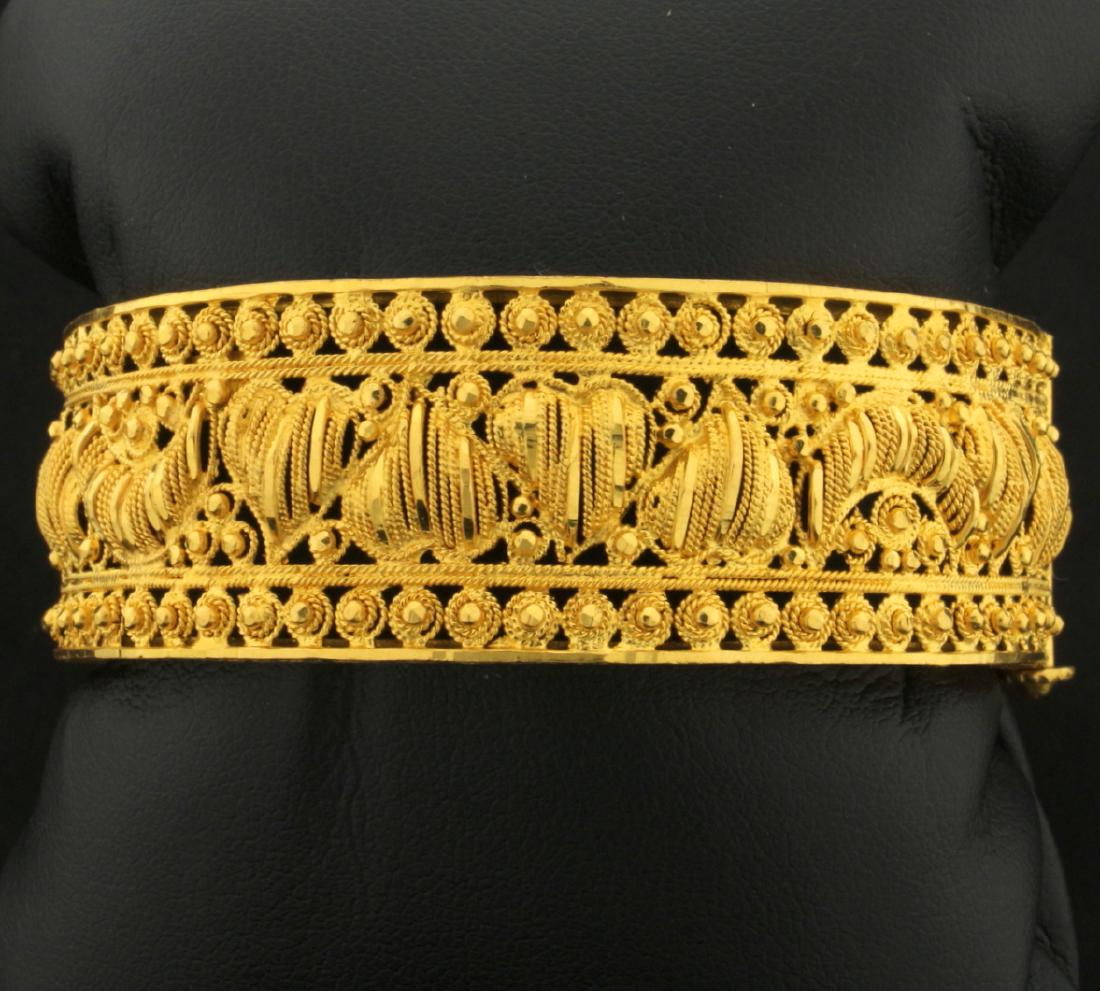 22K Yellow Gold Heavy Bangle Bracelet with Heart and: In 22K Yellow Gold. 21mm wide. Screw safety clasp. hinges, open/close. 2 1/4 inch inside diameter. 52.4g