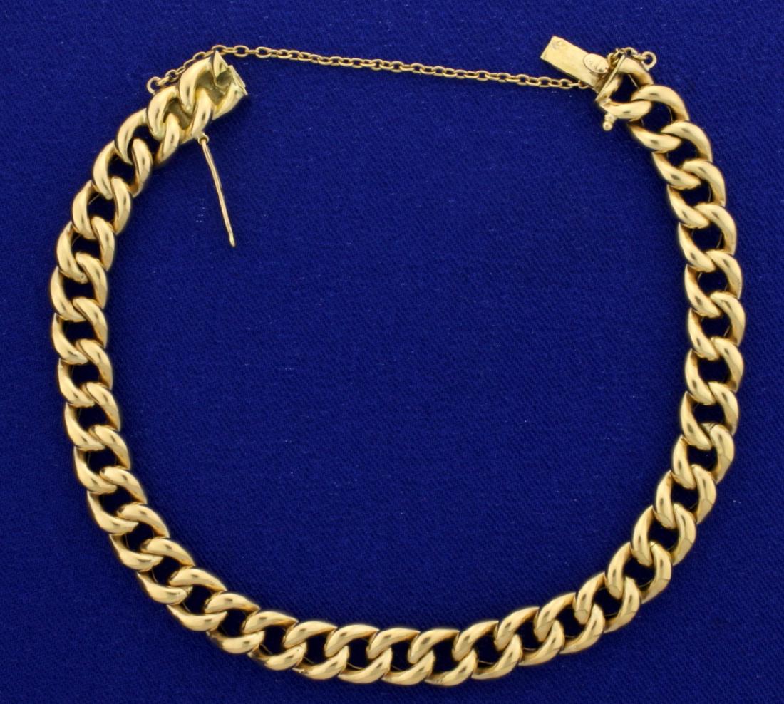 Curb Link Bracelet in 18K Yellow Gold: In 18K Yellow Gold. 8 1/2" long with safety clasp and chain. 8mm wide. 15.9g