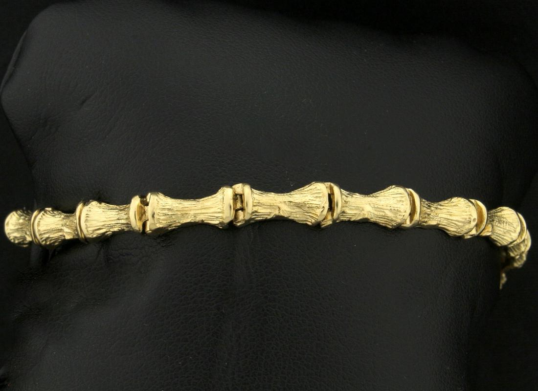 Bamboo Style Bracelet in 14k Yellow Gold: In 14k yellow gold. 7" long and 5.3mm thick with safety chain and clasp. 14.4g.