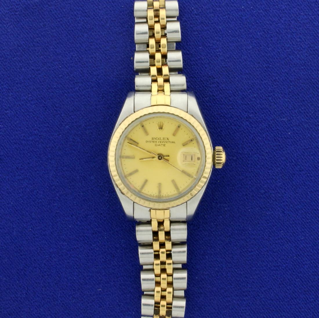 Rolex Date Two Tone Woman's Watch with Champagne Face: In Stainless Steel and 18K Yellow Gold. Serial Number 7207254, made in 1982, guaranteed authentic. Movement runs great. Has some scratching on crystal, has some stretch on band. 49.9g