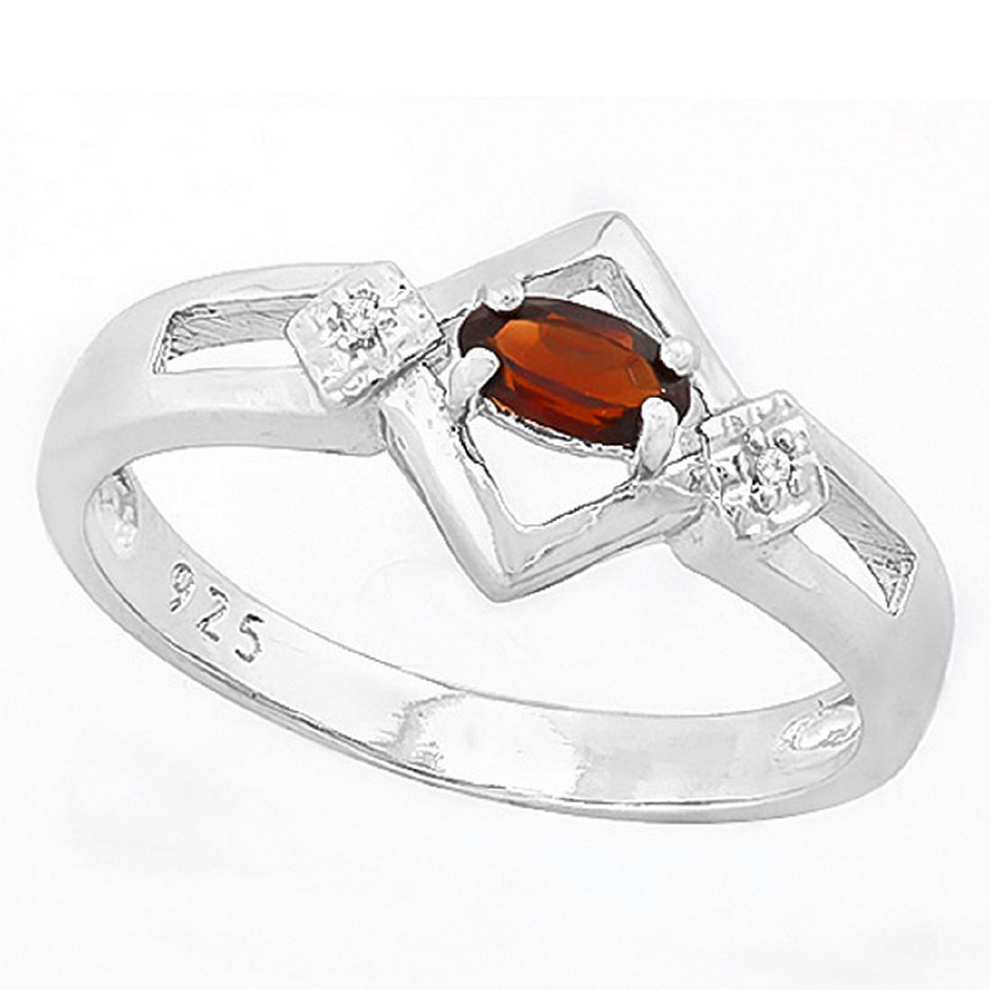 Art Deco Inspired Garnet and Diamond Ring in Sterling: Art Deco inspired ring with 1/3ct oval cut Garnet gemstone and 0.01ctw diamond accent. Set in Platinum over Sterling Silver. Size 8. 2.2g
