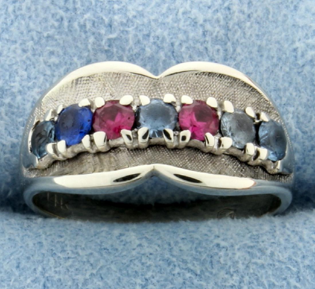 Ruby, Sapphire, Aquamarine, and Blue Topaz Ring in 14k: 14K white gold. The ring contains 3mm round high quality ruby, sapphire, aquamarine, & topaz gemstones. Some stones have some minor abrasion or chips. Size 6.5 4.7g