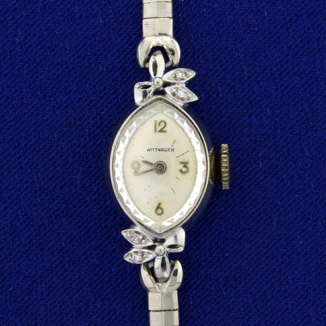 Antique Women's Wittnauer Watch with Diamonds: 10K White Gold Filled and Stainless Steel. Wind-up movement runs great. Contains four high quality .01ct round Diamonds. 6 1/4 inches long. Is in great condition for its age with only minimal scratchi