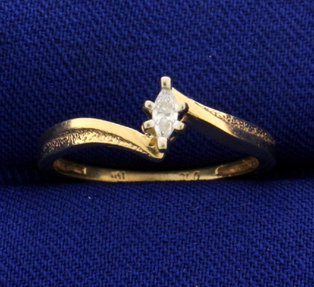 Marquise Diamond Solitaire Bypass Ring: In 10k yellow gold. Contains a high quality .05ct marquise diamond, SI clarity/H color. Size 5. 1.6g.