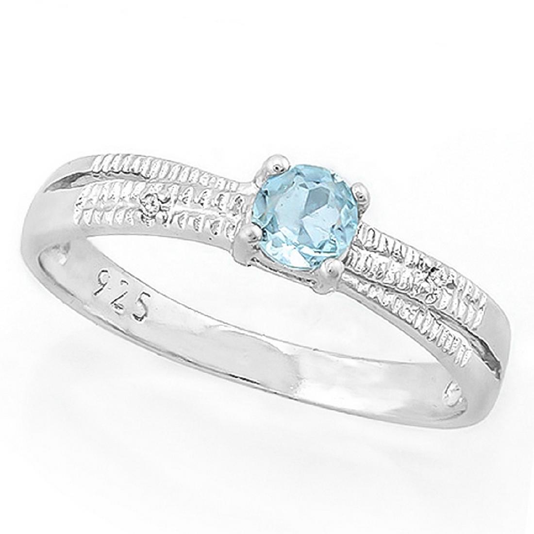 Criss Cross Sky Blue Topaz Ring with Diamond in: Sweet 4mm genuine Sky Blue Topaz gemstone set in a criss cross mounting with 0.01ctw genuine Diamond accent. Can be stacked or worn alone! Mounting is Platinum over Sterling Silver. Size 7. 1.6g
