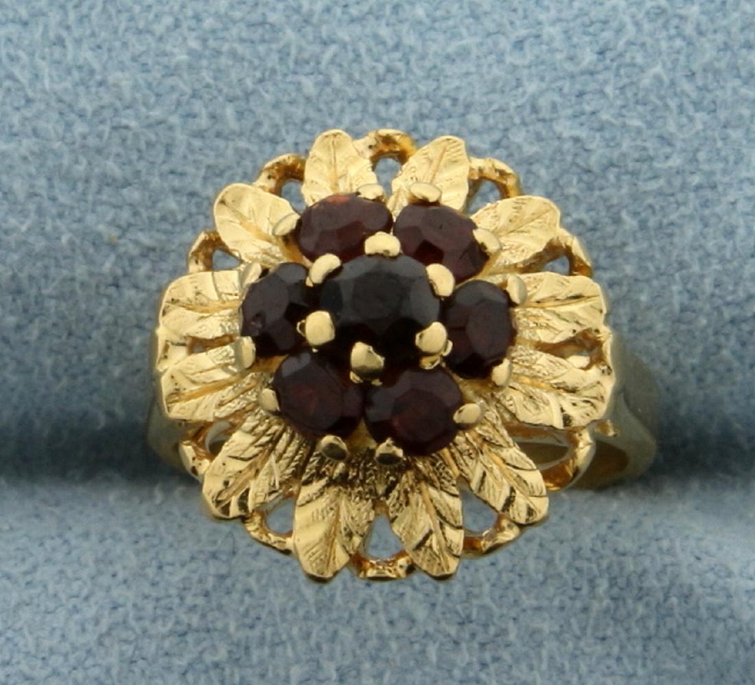 Garnet Child's Flower Ring in 18K Yellow Gold: In 18K Yellow Gold. Contains seven natural high quality Garnet gemstones ranging from 3 to 4mm each with beautiful red color and excellent clarity. Size 1 1/2. 4.7g