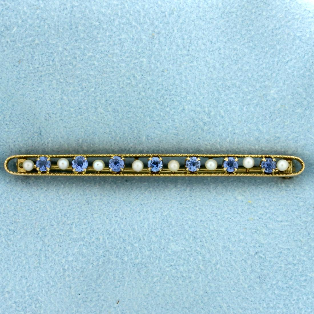 Antique Spinel and Seed Pearl Pin in 14K Yellow Gold: In 14K Yellow Gold. Contains seven 2.5mm natural Spinel gemstones with bright blue color and excellent clarity. Also contains eight 1.85mm Seed Pearls. Beaded edge. 2" long. 2.7g