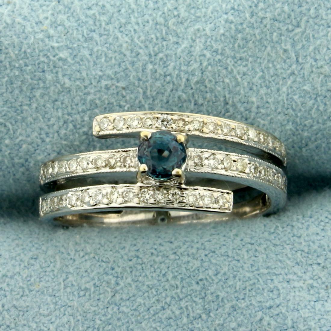 Natural Alexandrite and Diamond Wrap-Around Ring in 18K: In18K White Gold. Contains a high quality natural 3.5mm round color changing Alexandrite that changes from green to red depending on light source. Also contains and forty high quality 1/2pt Diamonds.