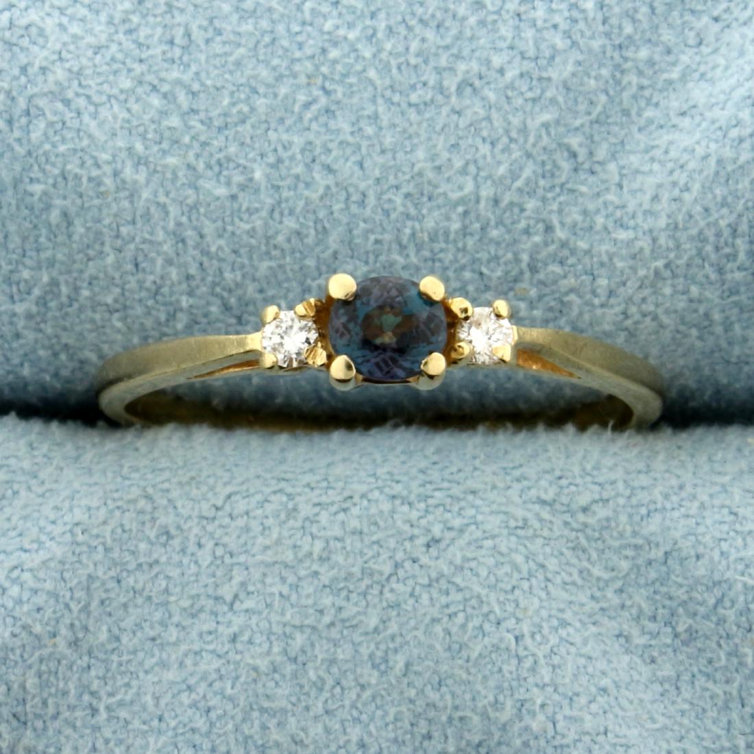 Natural Alexandrite and Diamond Ring in 14K Yellow Gold: In 14K Yellow Gold. Contains a high quality natural oval 4x3.6mm Alexandrite Gemstone that changes from green to vibrant purple depending on light source and with excellent clarity. Also contains two